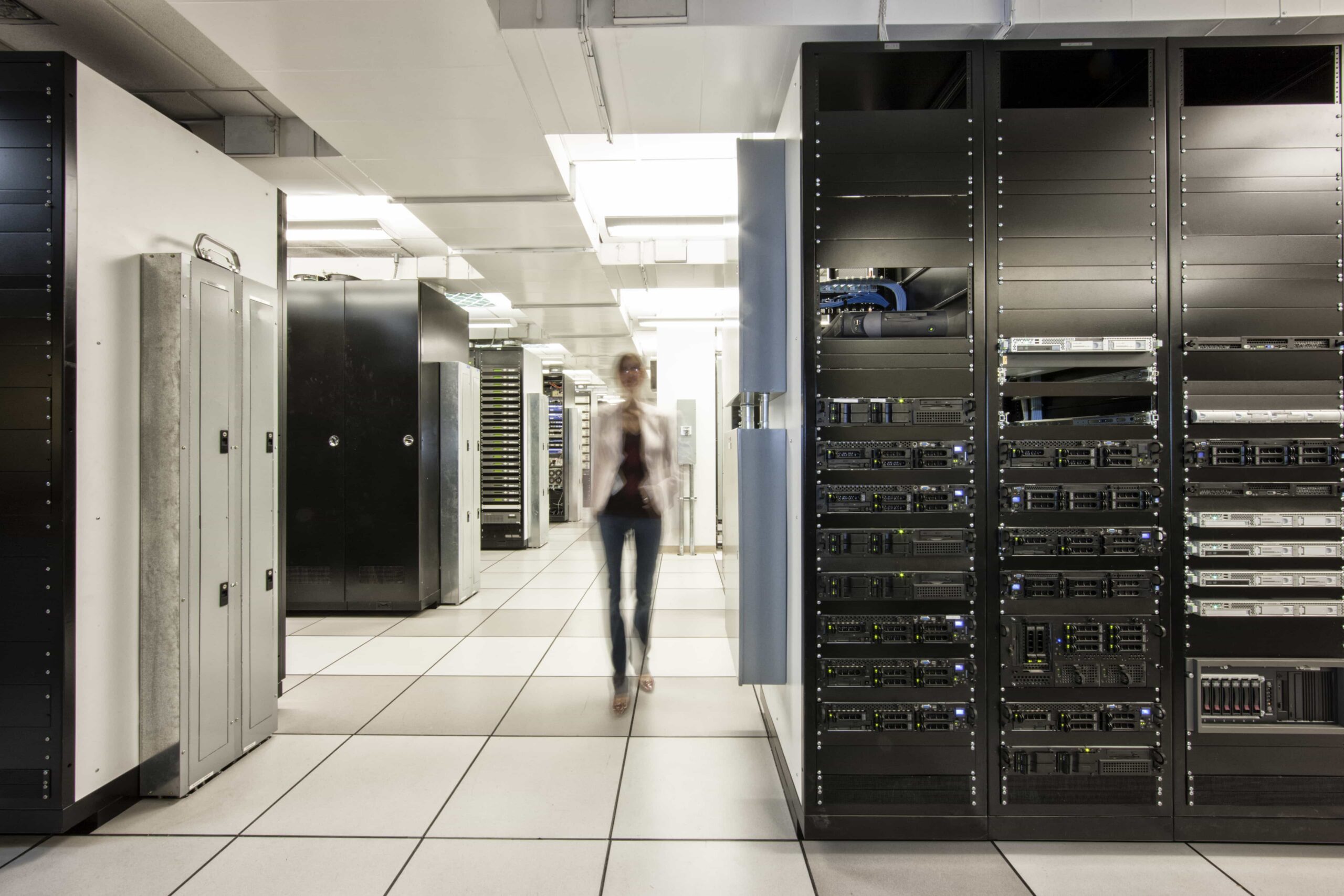 Computer server room racks with technician in back