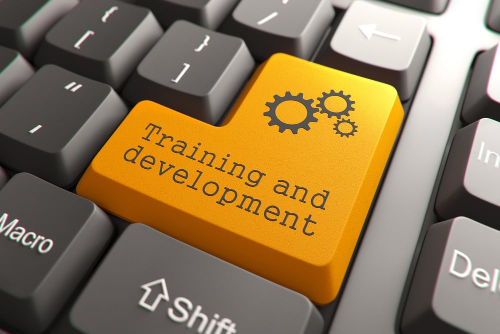 Training and development orange button on computer keyboard
